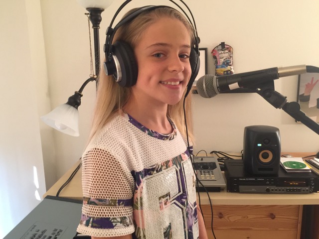 A 12 year old girl student making a recording during her singing lesson